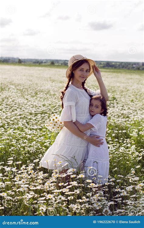 Mother With Daughter In A White Dress And Hat Stand Stock Photo Image