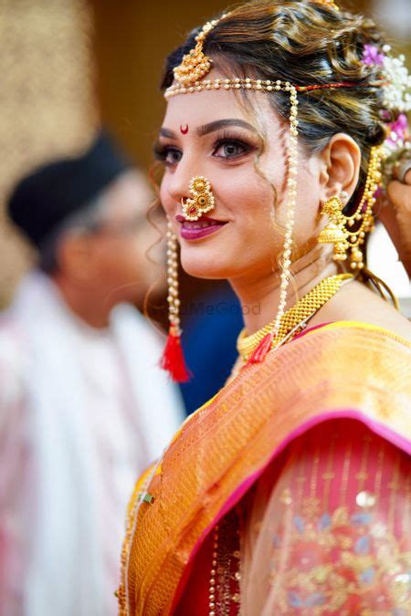 Photo Of A Marathi Bride In A Yellow Saree With Red Border