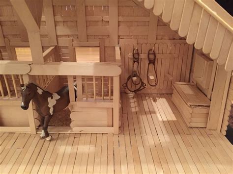 A Toy Horse Is Standing In The Middle Of A Wooden Room With Stairs And
