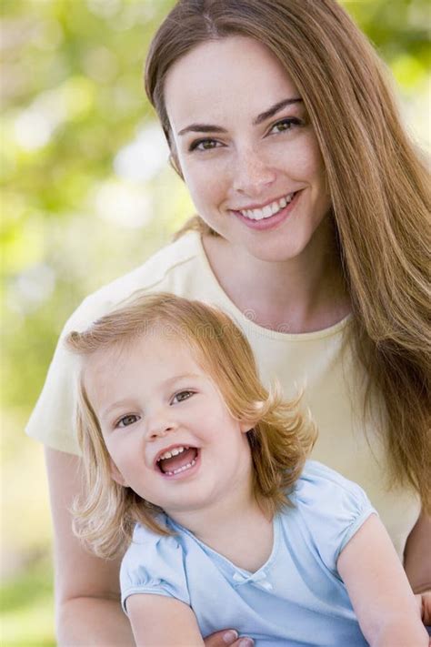 Mother Holding Daughter Outdoors Smiling Stock Photo Image Of Four
