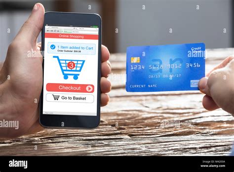 Businesspersons Hand Doing Online Shopping On Smartphone With Debit