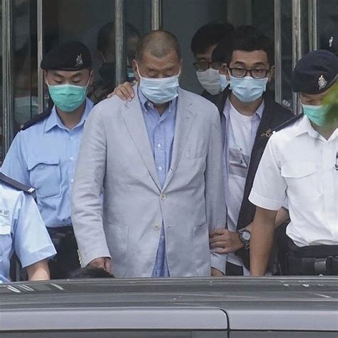 A handout photo from apple daily showing hong kong business tycoon jimmy lai led by police officers during a search at the headquarters of apple daily. Jimmy Lai: Arrested Hong Kong tycoon tells protesters to ...