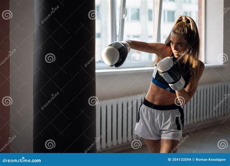 The Girl Is Preparing For A Boxing Competition And Trains Punches On A