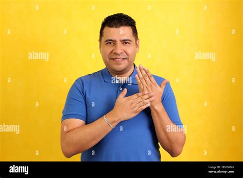 Dark Haired Latino Adult Man Uses Sign Language Typical Of Deaf People