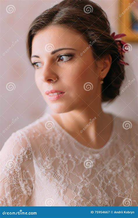 close up portrait of beautiful sensual bride in wedding dress looking over her shoulder indoors