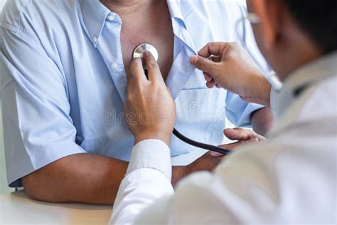 Doctor Using Stethoscope To Listen Checking Heart Rate Measuring To A