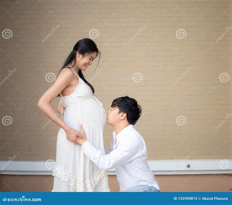 Asian Man Kissing His 9 Month Pregnant Wife`s Belly Stock Image Image