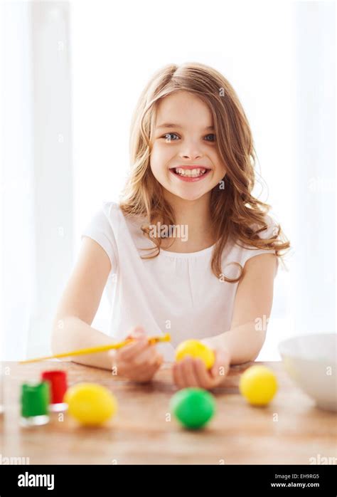 Smiling Little Girl Coloring Eggs For Easter Stock Photo Alamy