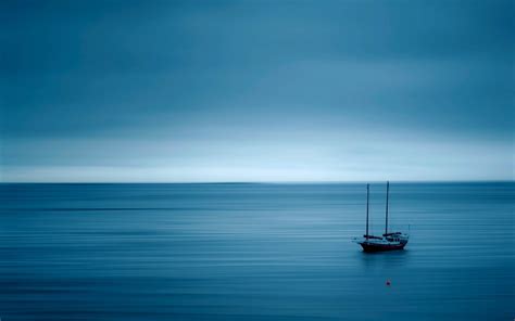 Download Calming Boat At Blue Sea Wallpaper