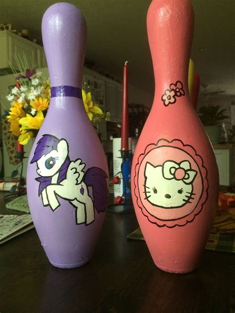 Two Pink And Purple Vases Sitting On Top Of A Wooden Table Next To Each Other