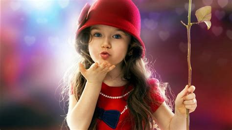 Little Cute Girl Is Blowing A Kiss Wearing Red Dress And Cap Having