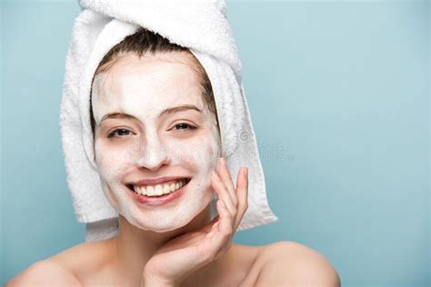 Cheerful Girl With Moisturizing Facial Mask Touching Face While Looking