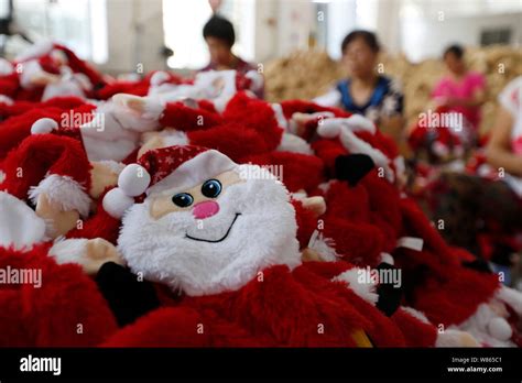 Female Chinese Workers Make Santa Claus Toys And Other Christmas