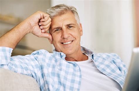 Mature Man Relaxing Smiling And Sitting On His Sofa At Home On Vacation Older Guy Comfortable