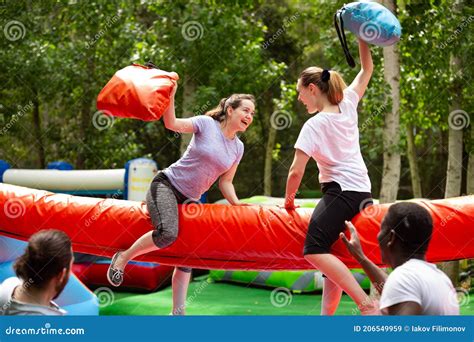 pillow fight between girlfriends in an amusement park stock image image of fight contest