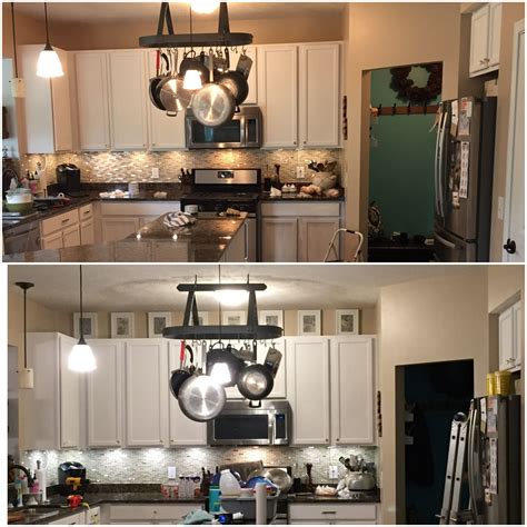 20 surprising tips on how to paint kitchen cabinets. Above kitchen cabinet decor. Simple picture frames with toile fabric. Clean and decluttered deco ...