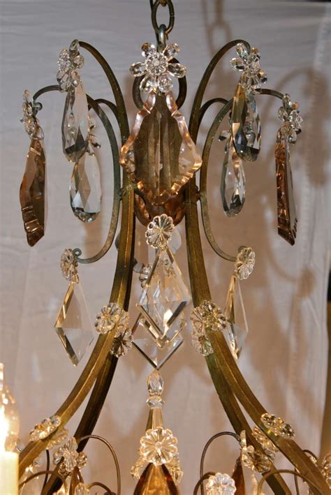 It fits in with anything, and it makes anything look better. Large French Wrought Iron and Crystal Chandelier by Maison ...