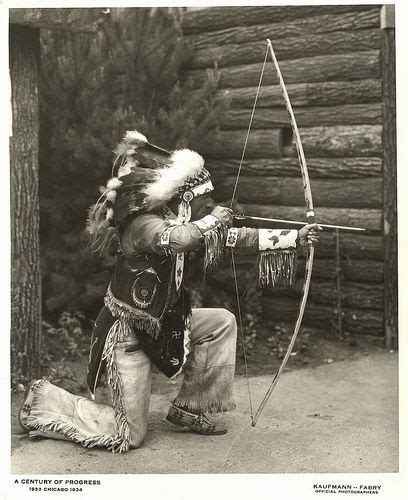 American Indian Demonstrating The Use Of A Bow And Arrow Native