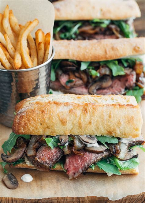 This steak bomb sandwich recipe combines tender shaved steak, melted provolone cheese, caramelized onions, mushrooms sautéed in bourbon, and our roasted garlic aioli into one amazingly good steak bomb sandwich. Steak Sandwich Recipe with Horseradish Mayo | Striped Spatula