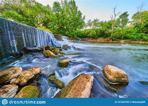 Manmade Dam Creating Waterfalls Into Algae Rocks In Forest Stock Image