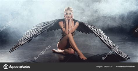 Beautiful Sexy Woman Black Angel Wings Sitting Touching Face Posing