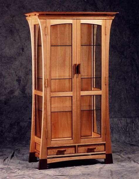 The secretary drop desk has an oval shaped beveled mirror above and. Curio Cabinet: A tall and skinny cabinet with glass doors ...