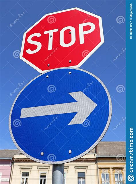 Stop Sign And Arrow Sign At The Road Crossing Stock Image