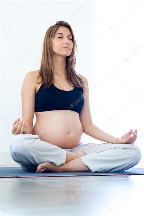 Pregnant Woman Relax Doing Yoga Sitting In Lotus Position Stock