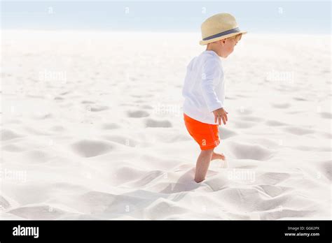 Baby Boy Standing On The Beach Stock Photo Alamy