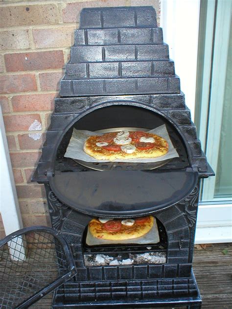 It features cast iron construction. . No bread is an island: First pizzas in wood-fired chiminea