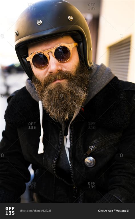 Portrait Of Bearded Biker Wearing Helmet And Sunglasses Stock Photo
