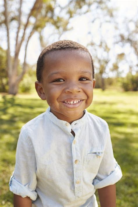 Outdoor Head And Shoulders Portrait Of Young Boy In Park Stock Image