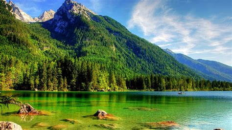 Beautiful Landscape View Of Green Trees Covered Mountains Under Blue