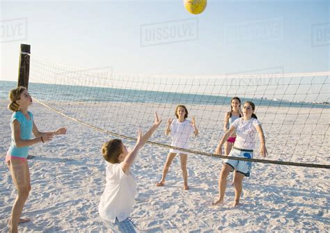 Group Of Kids Playing Beach Volleyball Stock Photo Dissolve