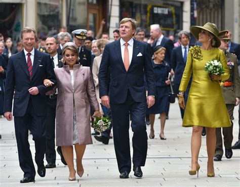 the dutch royal couple maxima and willem alexander walking through royal alexander couples