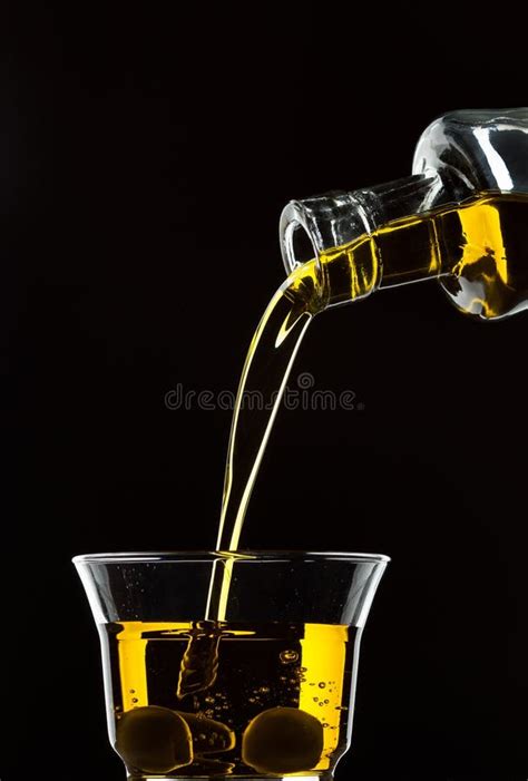 Pouring Olive Oil From A Bottle Into A Glass Stock Image Image Of