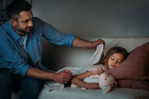 Father Covering Sleeping Daughter With Blanket Stock Image Everypixel