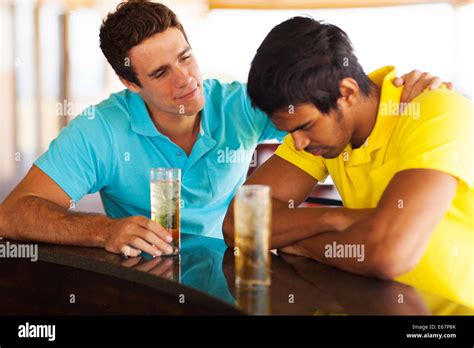 Young Man Sitting At Bar And Comforting His Sad Friend Stock Photo Alamy
