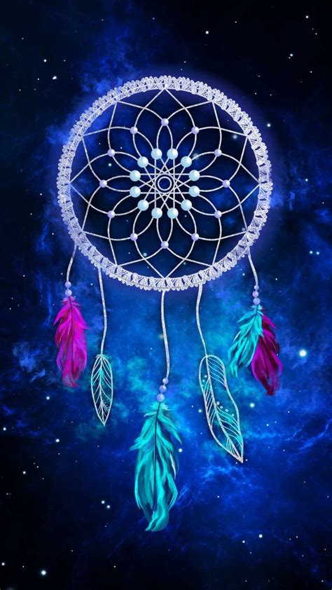 A Blue And Pink Dream Catcher With Feathers On Its Side In The Sky