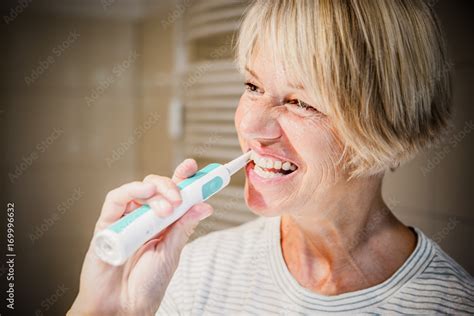 Mature Woman Is Brushing Her Teeth Foto De Stock Adobe Stock