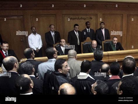 Journalists And Bodyguards Stand In The Cairo Court Room As Defendants