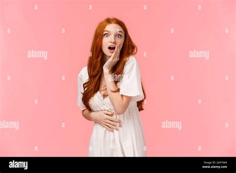 waist up portrait surprised and curious astonished redhead girl heard amazing news gossiping