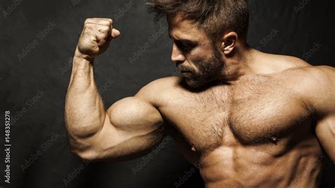 A Muscular Man Flexing His Biceps Stock Photo Adobe Stock