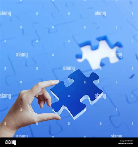 Female Hand Placing Last Piece Of Puzzle As Concept Stock Photo Alamy