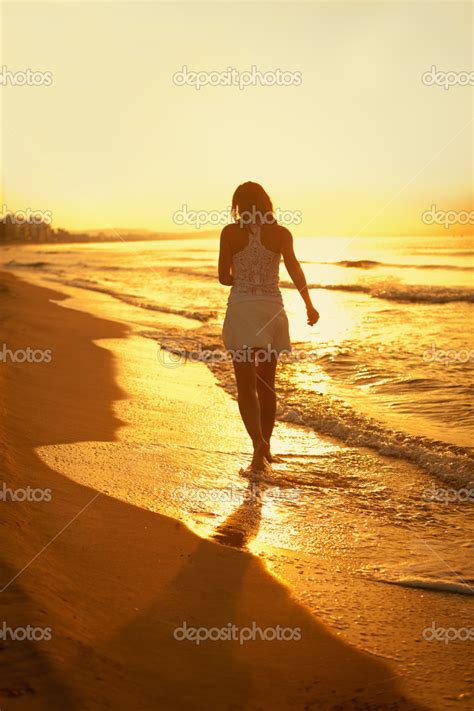 Beautiful Girl Walking Along Beach At Sunset — Stock Photo © Rimdream