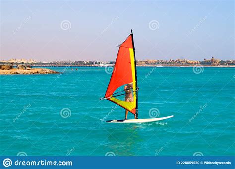 Windsurfing Sailing Surfboard With A Sail In The Sea Editorial Image