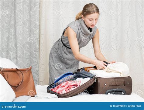 Beautiful Woman Packing Suitcase In Bedroom Getting Ready For Road Trip Stock Image Image Of