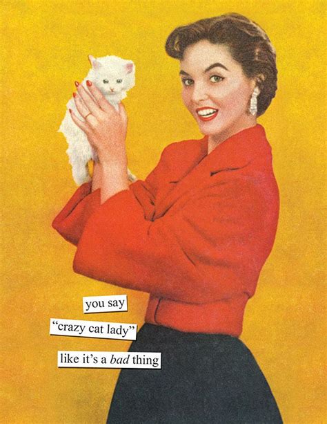 A Woman Holding A White Cat In Her Right Hand While Wearing A Red Shirt