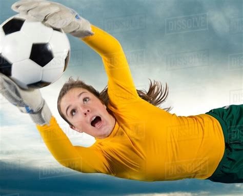 Soccer Player Catching Ball In Air Stock Photo Dissolve