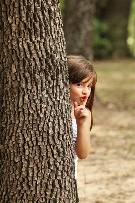Little Girl Hiding Behind Tree Free Stock Photo - Public Domain Pictures